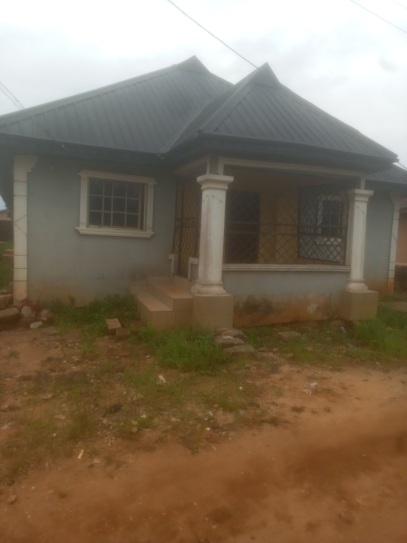 A house containing 3 bedroom flat, 2 bedroom flat at the back and one room and parlour selcon at the middle